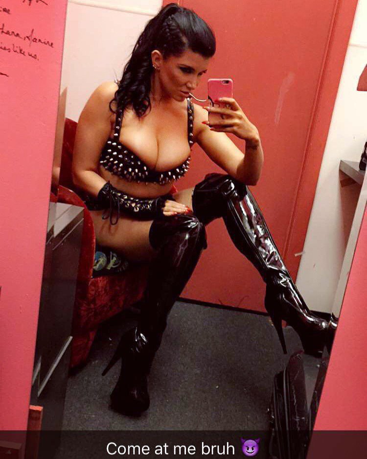 Romi Rain in leather boots taking selfie