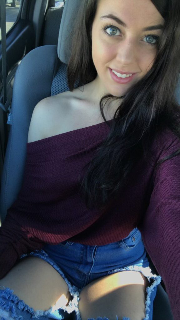 car selfie by Whitney Wright in ripped jeans