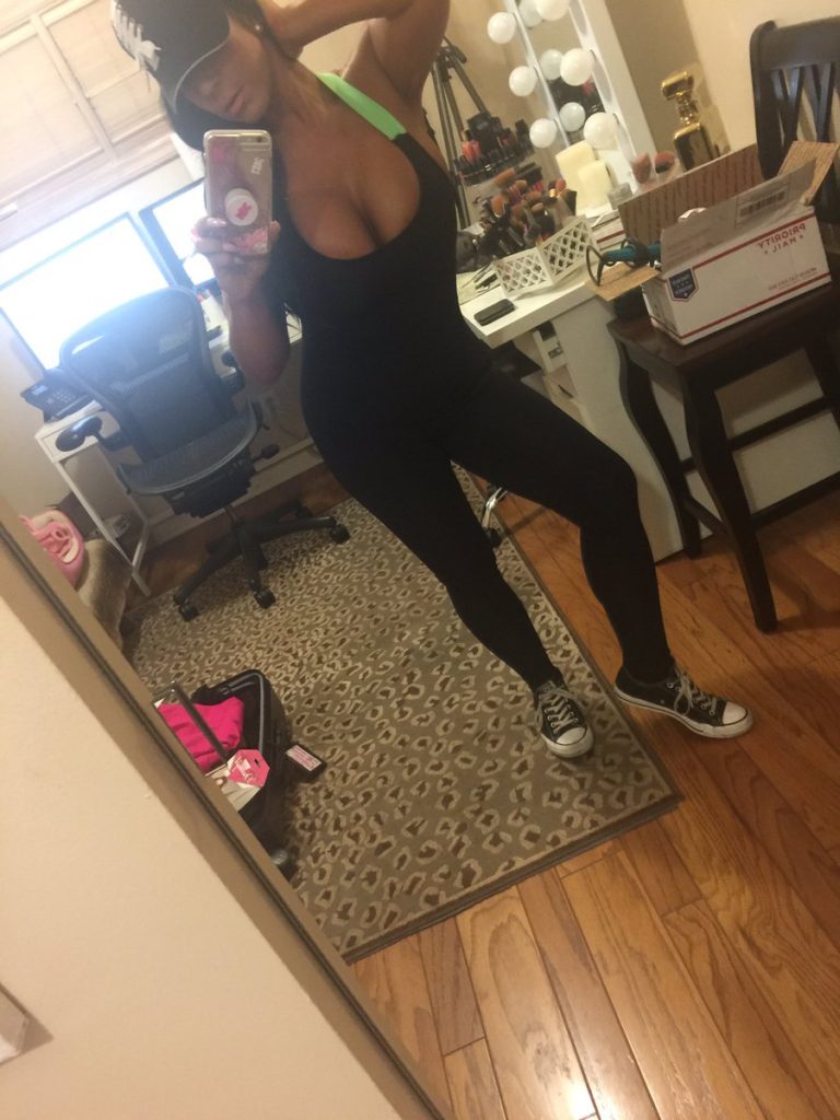 Raven Hart in sexy workout onesie taking selfie