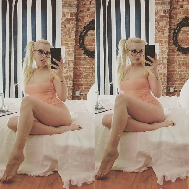 Camsoda cam model Lexi Belle with pigtails and glass taking selfie