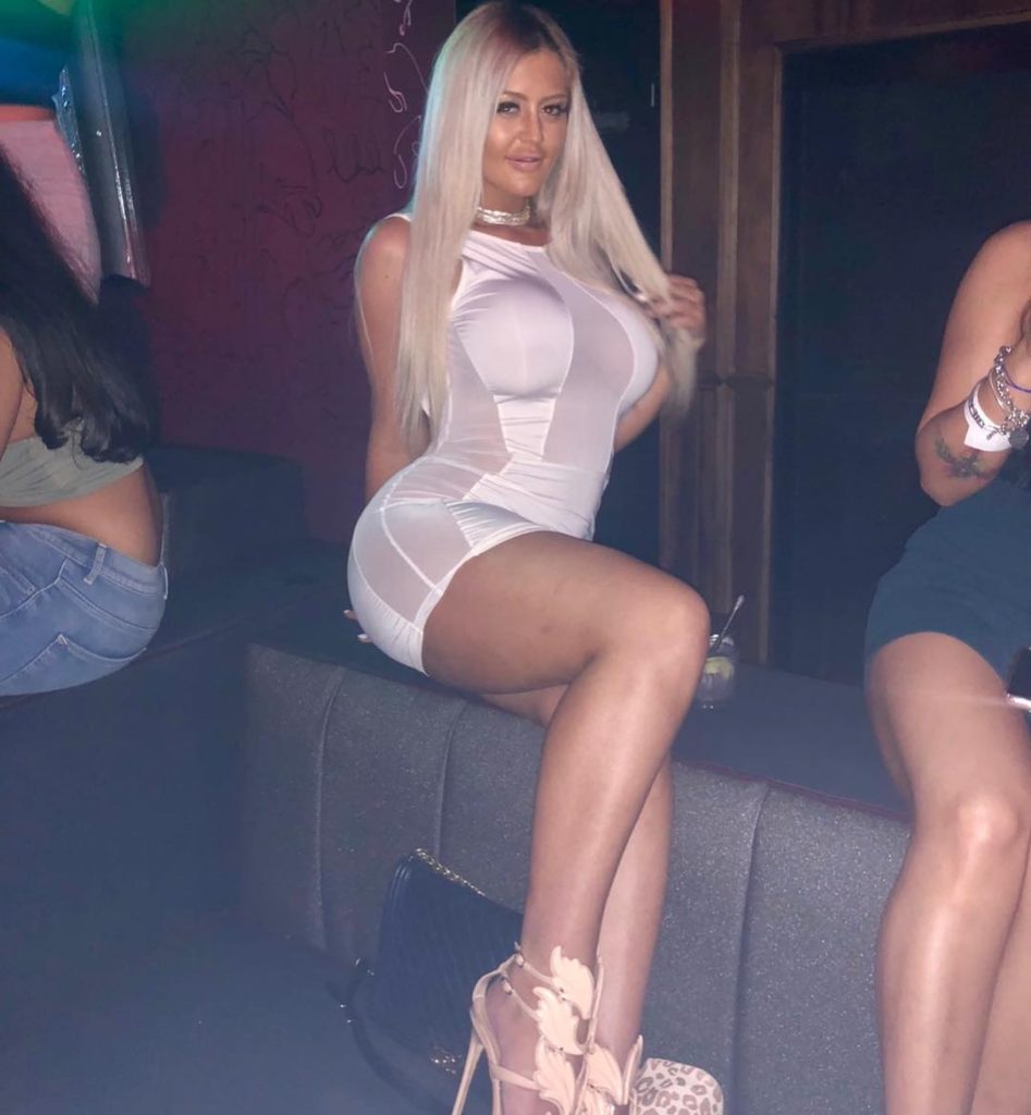 Danii Banks in tight white mini dress at club
